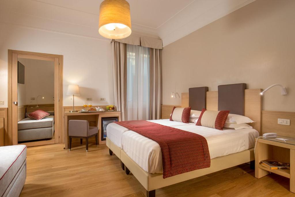 Postel nebo postele na pokoji v ubytování Hotel Nord Nuova Roma
