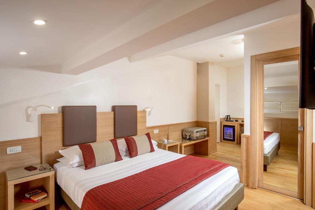 Postel nebo postele na pokoji v ubytování Hotel Nord Nuova Roma