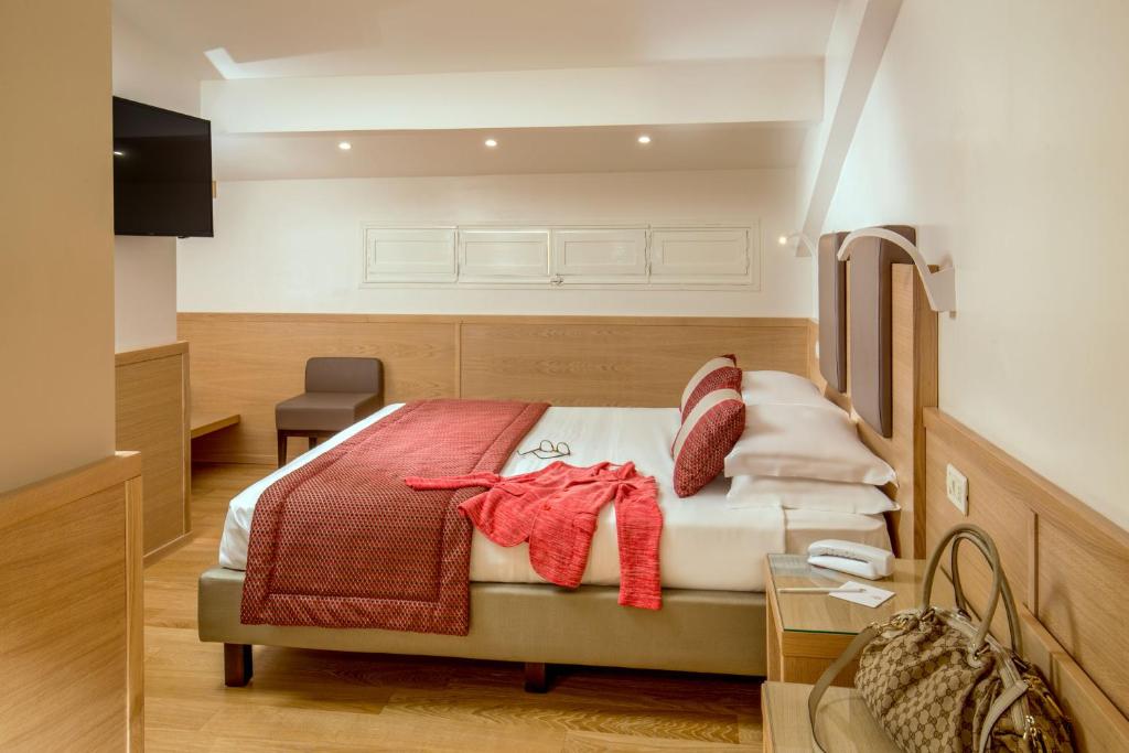 Postel nebo postele na pokoji v ubytování Hotel Nord Nuova Roma