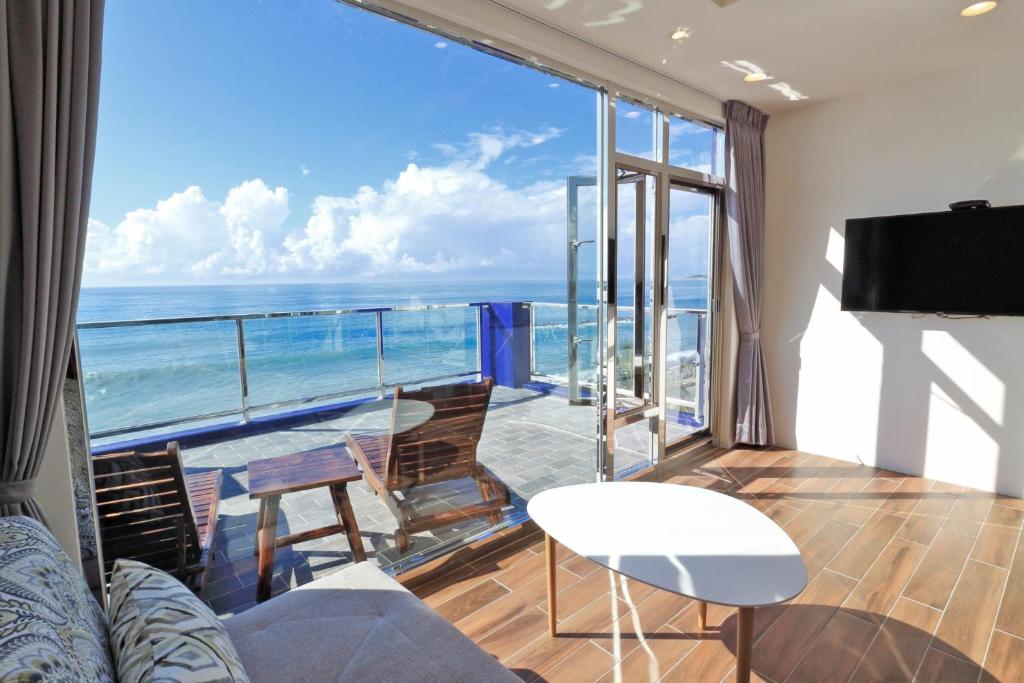 a living room with a view of the ocean at Two Home Inn in Hualien City