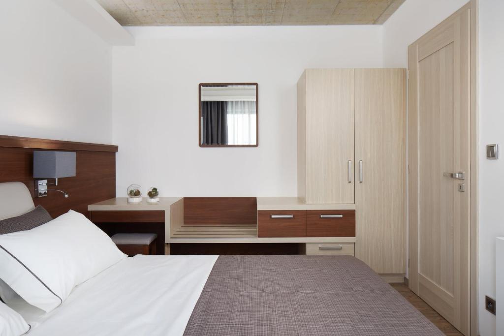 Postel nebo postele na pokoji v ubytování JBX Resort Apartments Lipno