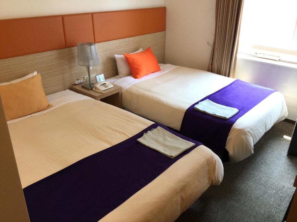 Postel nebo postele na pokoji v ubytování Hotel 1-2-3 Takasaki