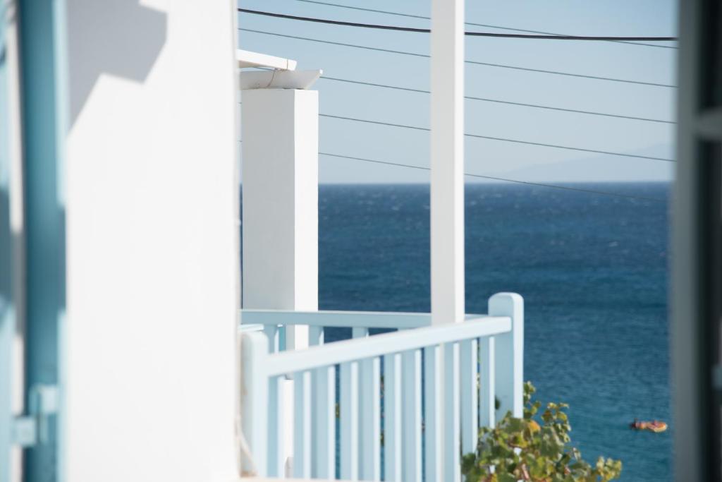 a view of the ocean from a house balcony at Paroscarmel studio-apartment in Logaras