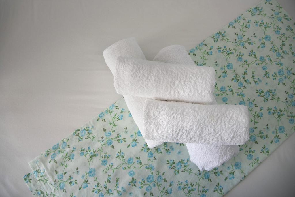 two towels sitting on top of a table at Paroscarmel studio-apartment in Logaras