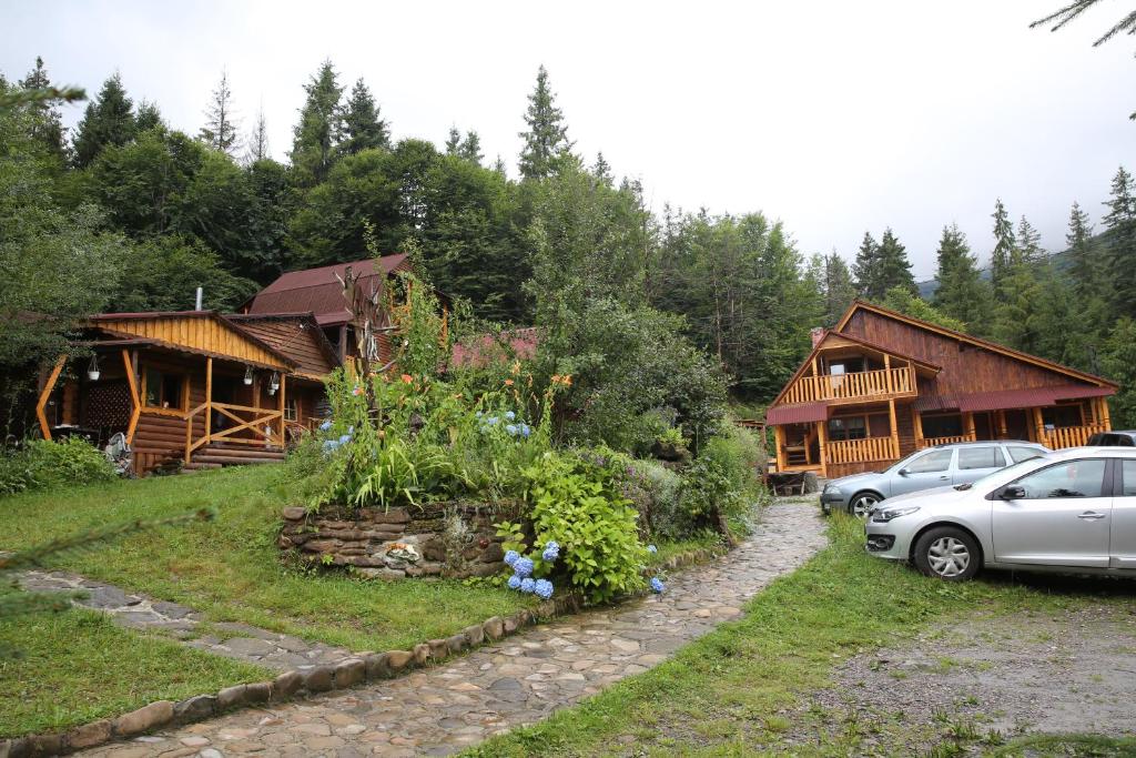 a couple of buildings with cars parked in front of them at Zarinok in Pilipets