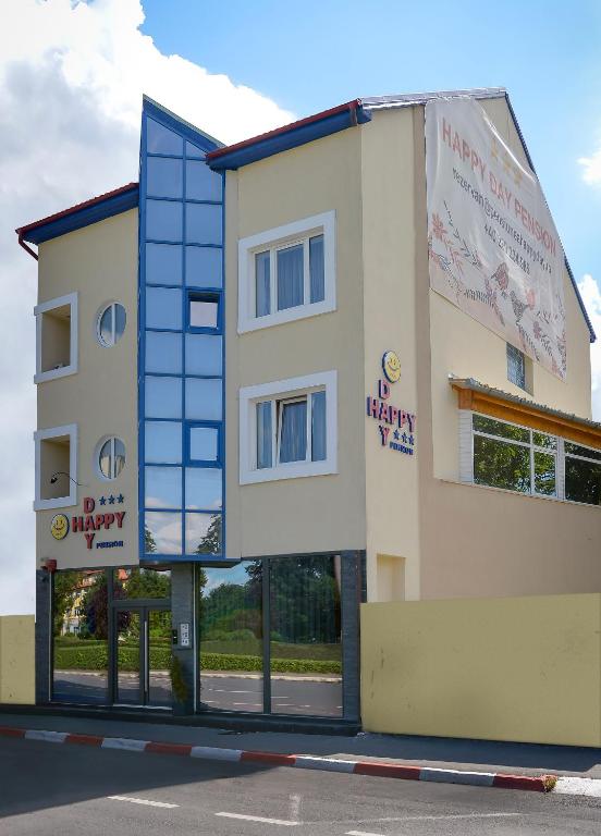 a building with a banner on the side of it at Pension Happy Day - motorcycle friendly in Sibiu