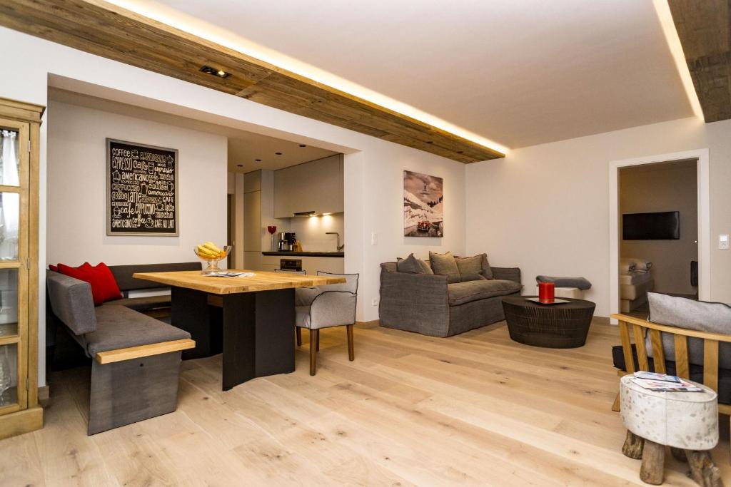 a living room with a table and a couch at Appartements Erwin Hüttl III in Neukirchen am Großvenediger