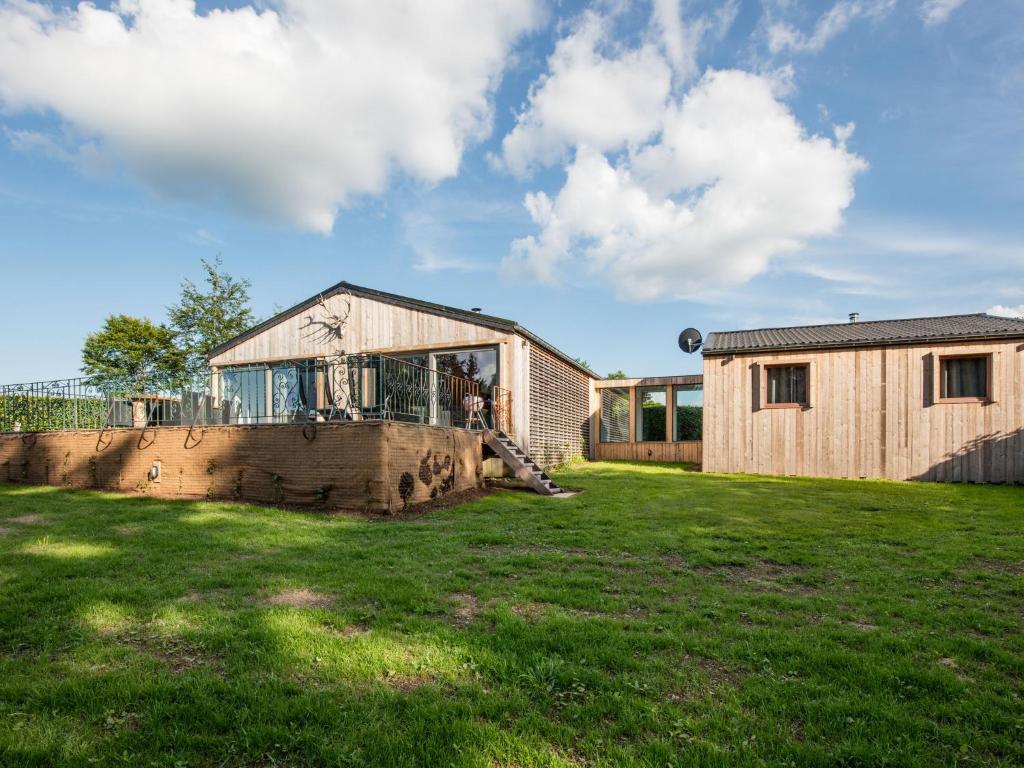 a home with a large yard with a building at Lush chalet near lake of B tgenbach in Wirtzfeld