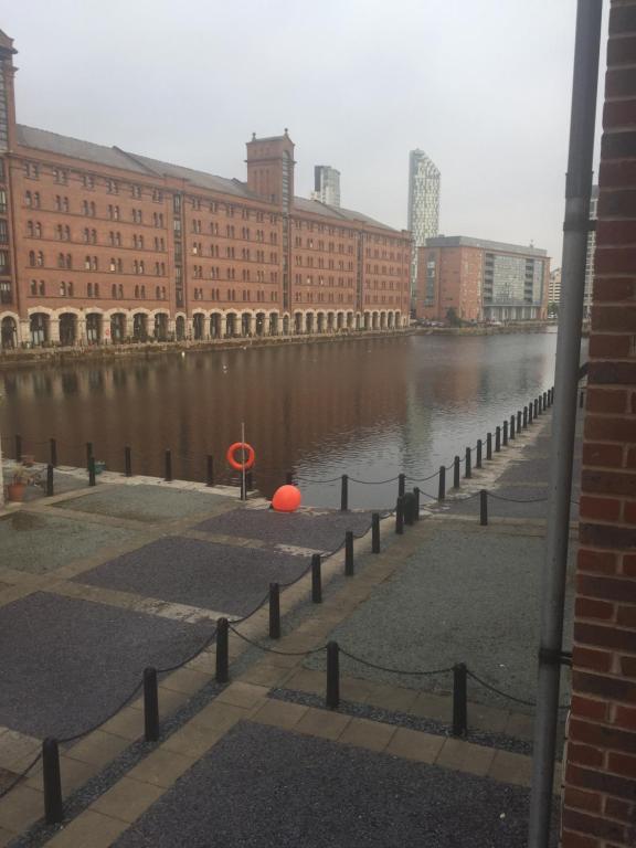 a large body of water with buildings in the background at Fabulous Dockside Apartment in Liverpool
