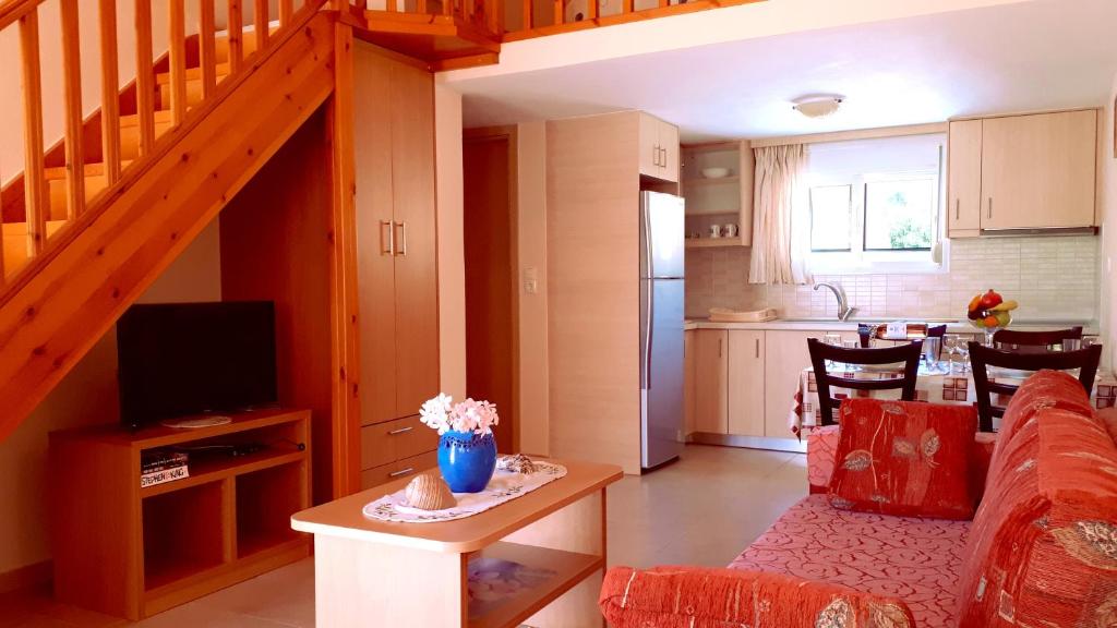 a living room with a couch and a kitchen at Creta Spirit in Plakias
