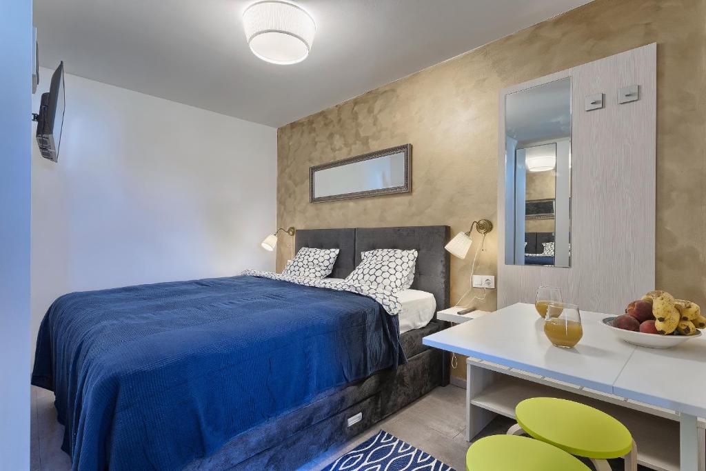 a bedroom with a bed and a table and chairs at Luxury flats in city centre in Pula