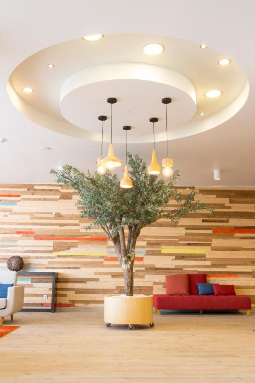 a tree in a room with a wall of wood at Star inn Peniche in Peniche