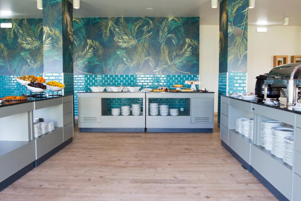 a large kitchen with blue tile walls at Star inn Peniche in Peniche