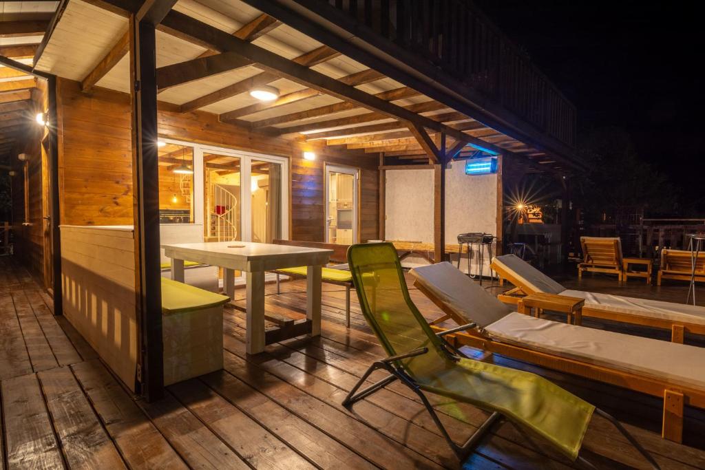 a room with a table and chairs on a deck at Hakuna Matata Apartments in Ulcinj