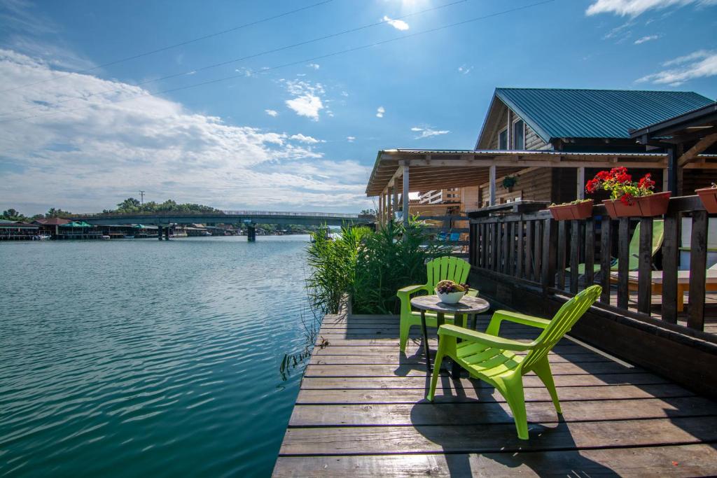 a table and chairs on a dock next to the water at Hakuna Matata Apartments in Ulcinj
