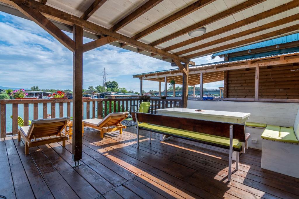a deck with a ping pong table and two chairs at Hakuna Matata Apartments in Ulcinj