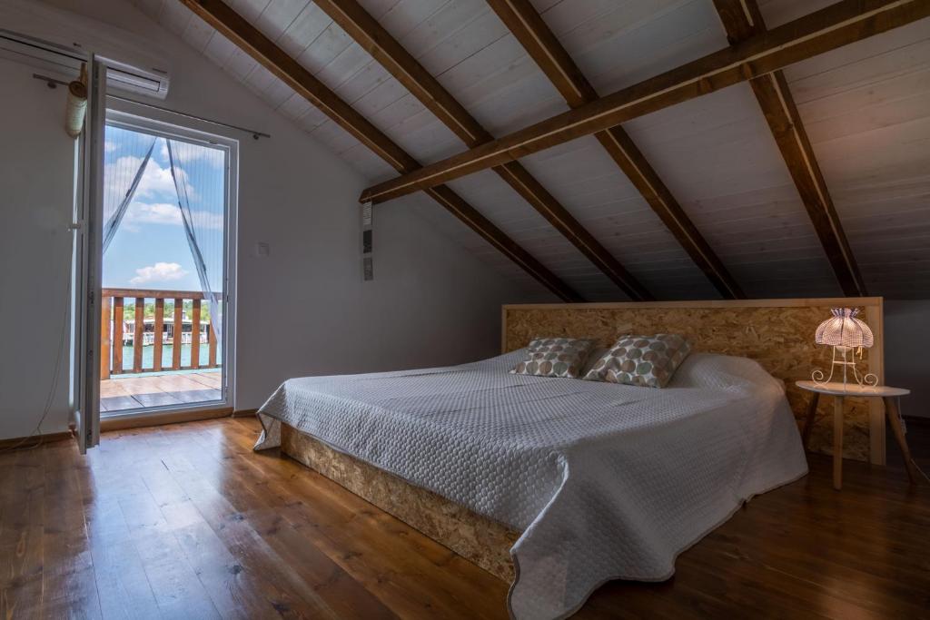 a bedroom with a bed and a large window at Hakuna Matata Apartments in Ulcinj