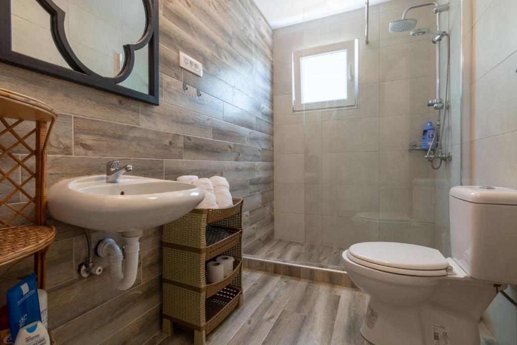 a bathroom with a sink and a toilet at Hakuna Matata Apartments in Ulcinj