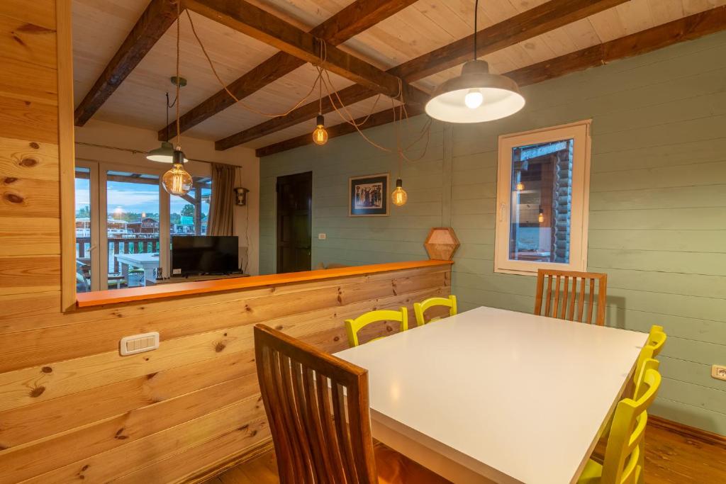 a dining room with a white table and chairs at Hakuna Matata Apartments in Ulcinj
