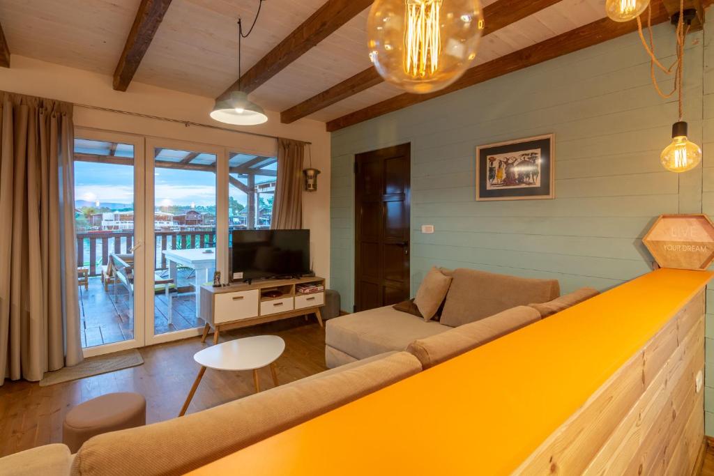 a living room with a couch and a television at Hakuna Matata Apartments in Ulcinj