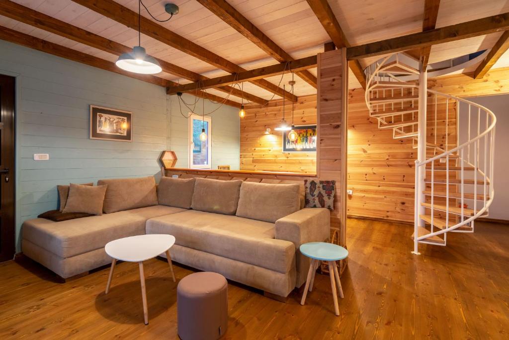 a living room with a couch and two tables at Hakuna Matata Apartments in Ulcinj