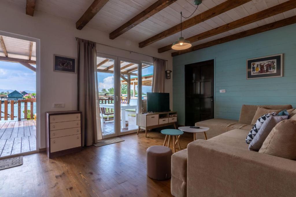 a living room with a couch and a television at Hakuna Matata Apartments in Ulcinj