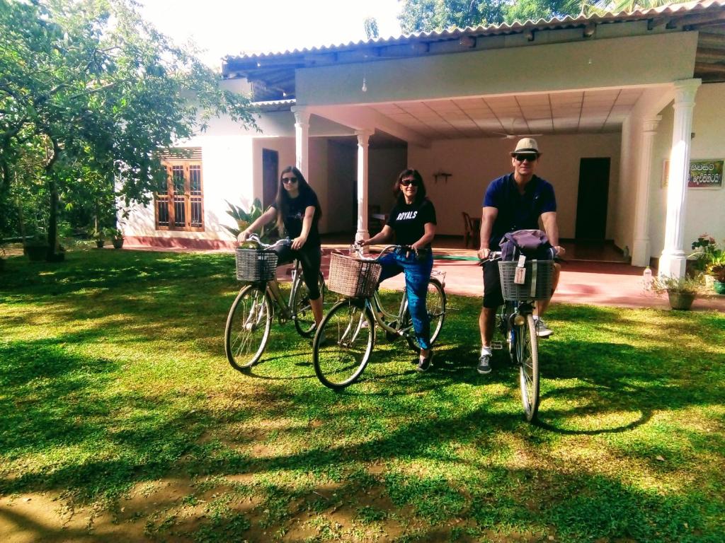 a group of people riding bikes in a yard at Siyapath Holiday Resort in Polonnaruwa