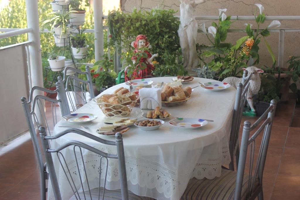 a table with a plate of food on it at Guest house Gidi in Sighnaghi