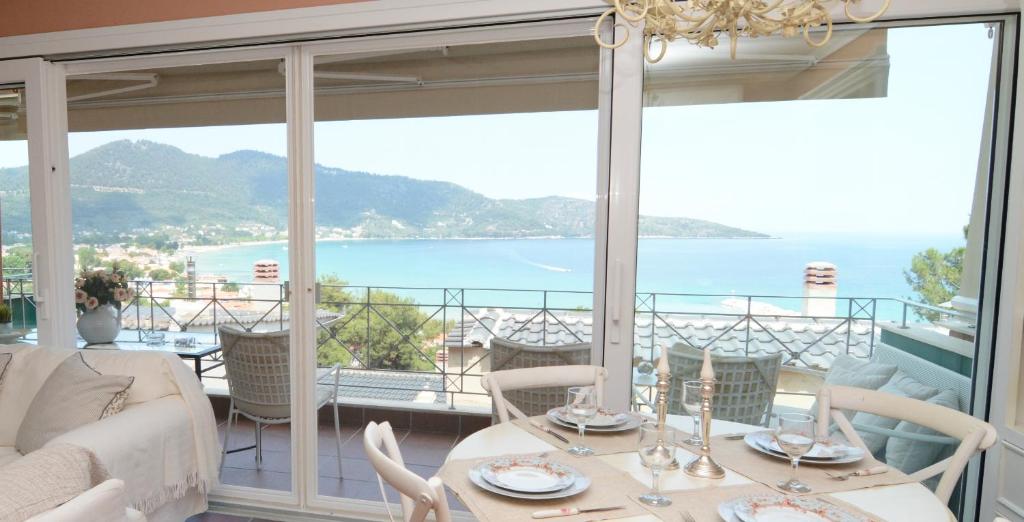a dining room with a view of the ocean at Villa Blue in Skala Potamias