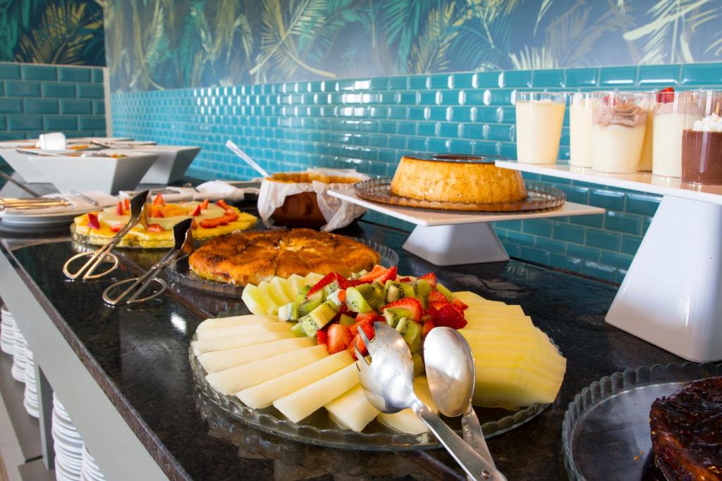 a buffet with cheese and vegetables on a counter at Star inn Peniche in Peniche