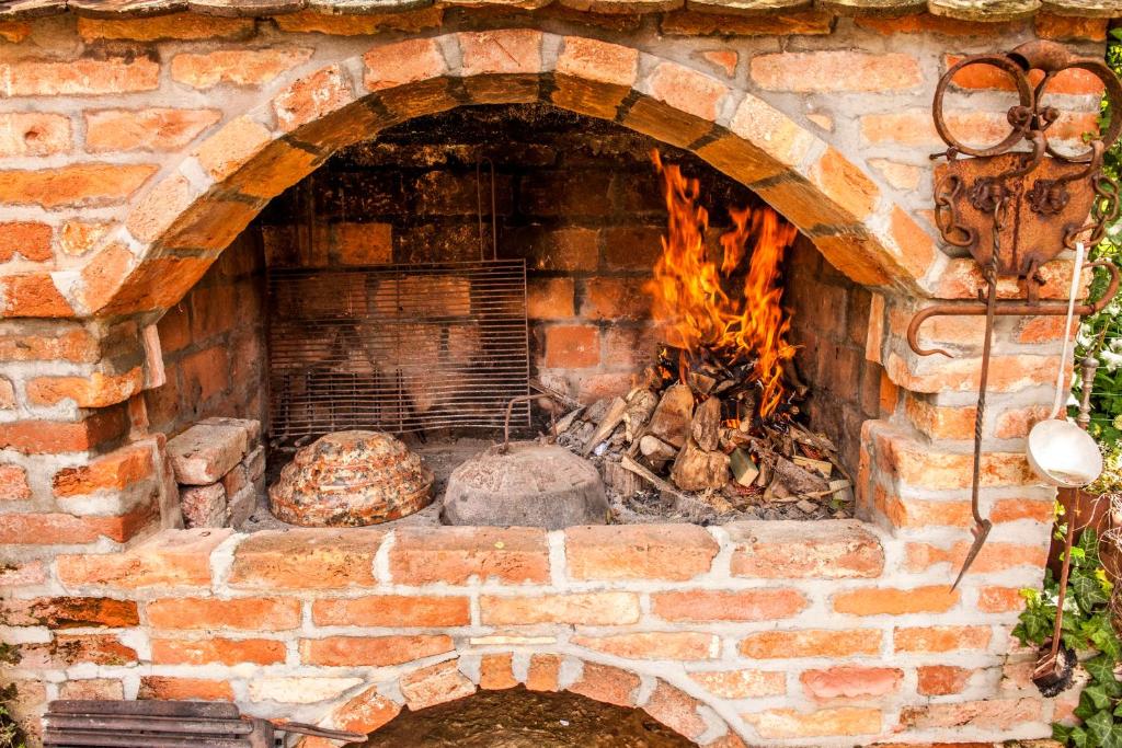 a brick oven with a fire in it at Country house with a pool in Medvednica Nature Park in Zagreb