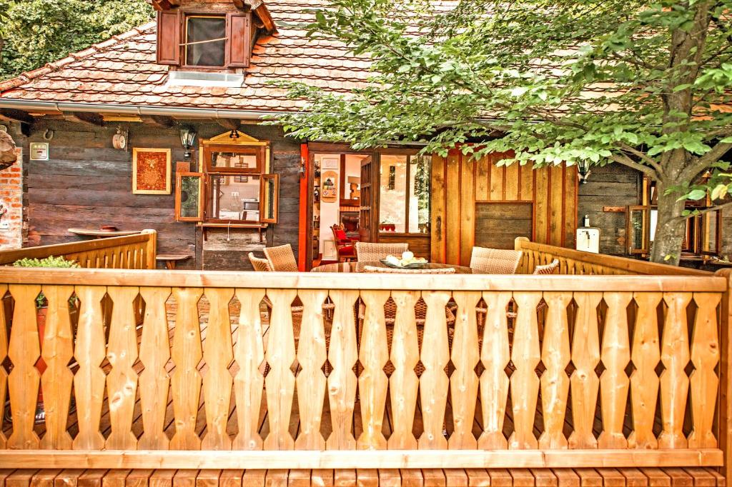 a wooden fence in front of a house at Country house with a pool in Medvednica Nature Park in Zagreb