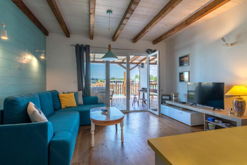 a living room with a blue couch and a table at Hakuna Matata Apartments in Ulcinj