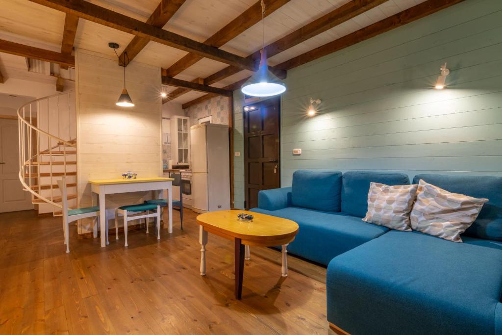 a living room with a blue couch and a table at Hakuna Matata Apartments in Ulcinj