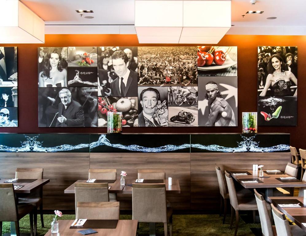 a restaurant with large pictures on the wall at Meliá Düsseldorf in Düsseldorf