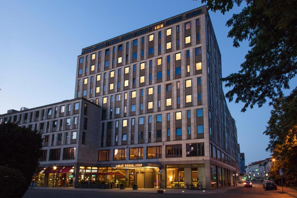 a tall black building with a store in front of it at Meliá Düsseldorf in Düsseldorf