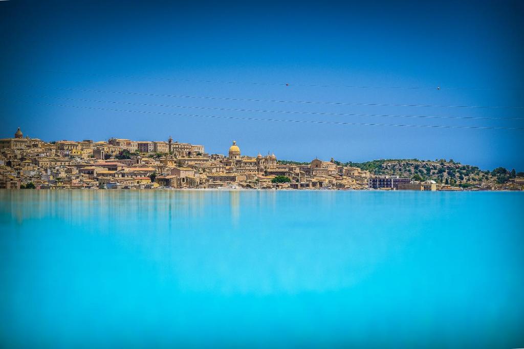 a large body of water with a blue sky at Baglio Genovesi in Noto