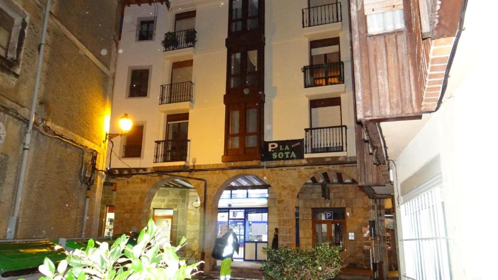 an old building with an archway in a courtyard at La Sota in Castro-Urdiales