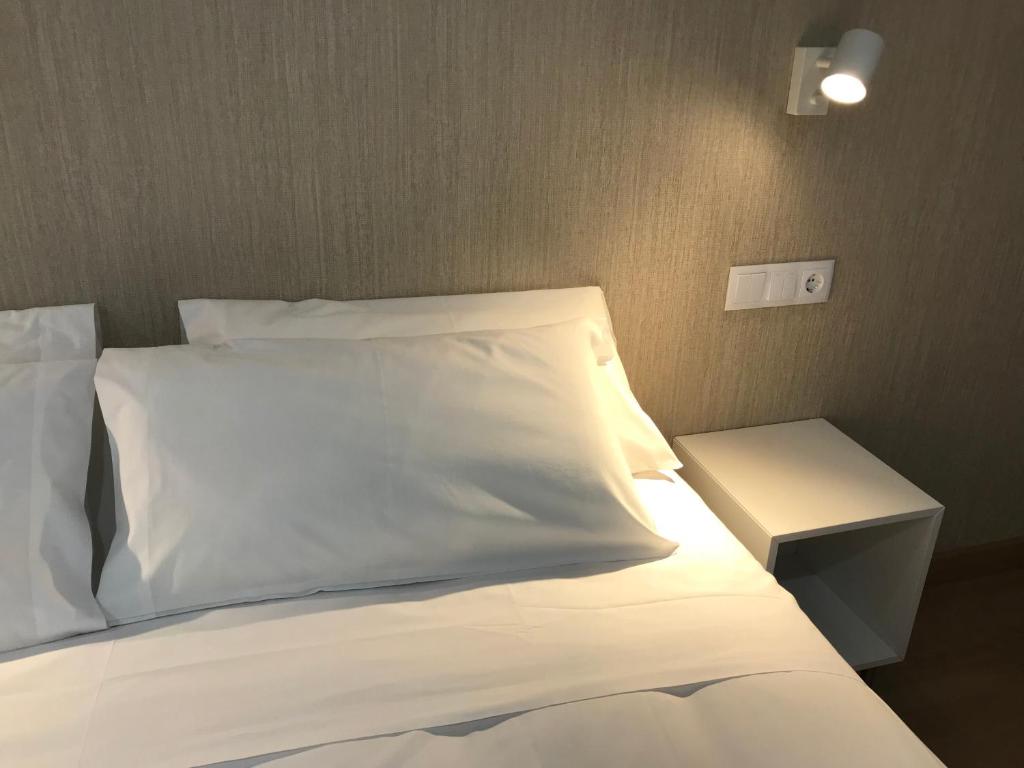 A bed or beds in a room at Apartamentos Areas