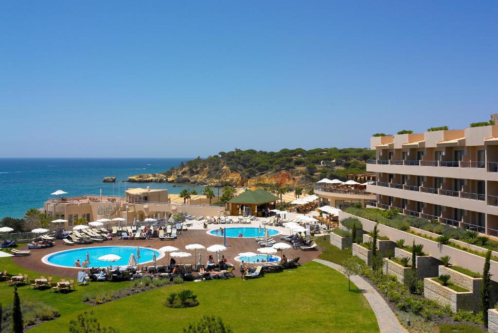 a view of a resort with two pools and umbrellas at Grande Real Santa Eulalia Resort & Hotel Spa in Albufeira