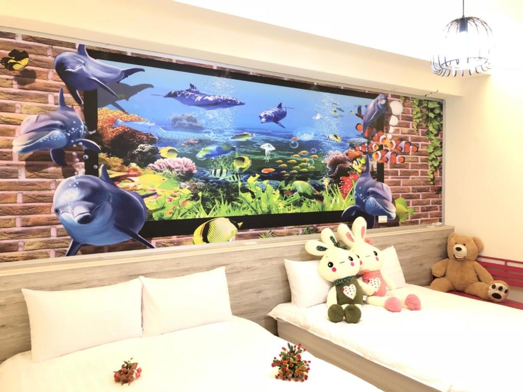 una camera con due letti e un grande acquario di Jiahui Elevator Homestay a Città di Taitung