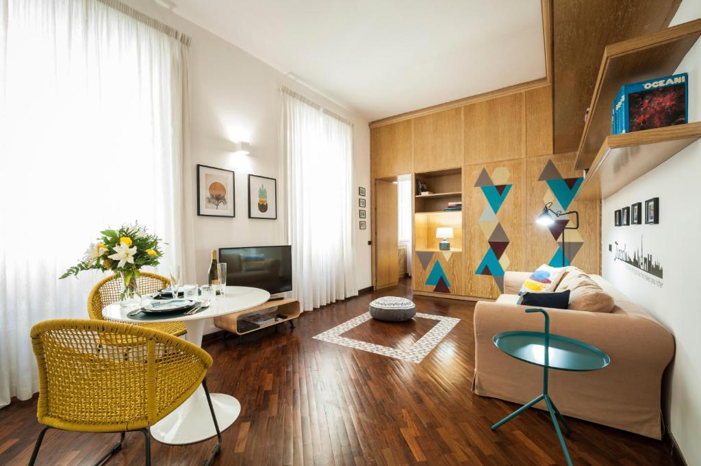 a living room with a couch and a table at Rome As You Feel - Baccina 95 Forum Apartment in Rome