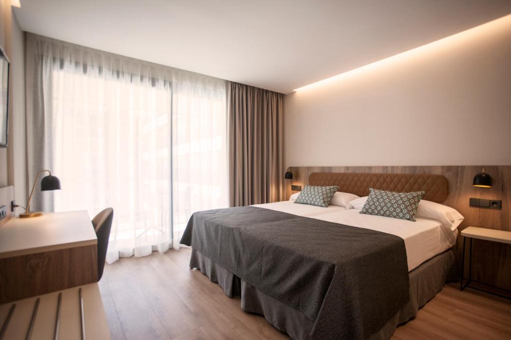 Łóżko lub łóżka w pokoju w obiekcie Hotel Presidente 4 sup