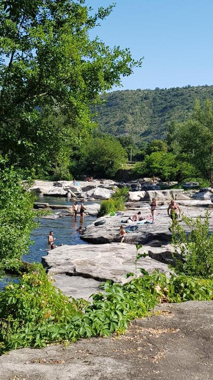 a group of people swimming in a river at Gite Le Moulin de Rosieres Moulin Champetier in Rosières