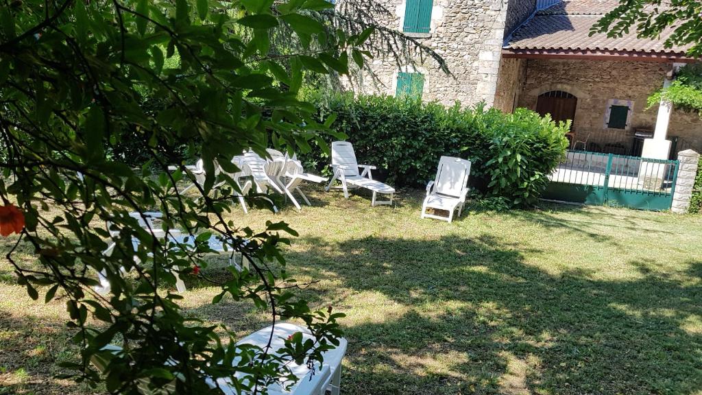 a group of chairs sitting in a yard at Gite Le Moulin de Rosieres Moulin Champetier in Rosières
