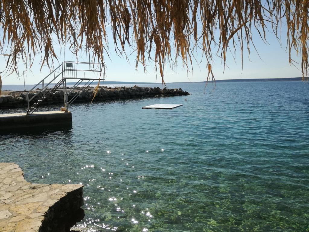 a boat sitting in the water next to a dock at Holiday Park Mandrice in Mandre