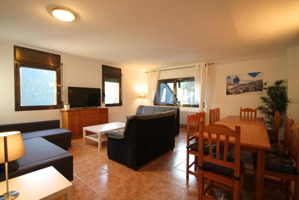 a living room with a couch and a table at Pont de Toneta 6,3 Atico Duplex, Ransol, Zona Grandvalira in Ransol