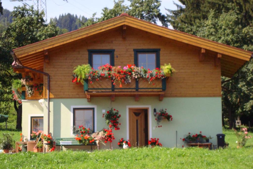 a small house with flower boxes on it at Haus Söllner in Lend