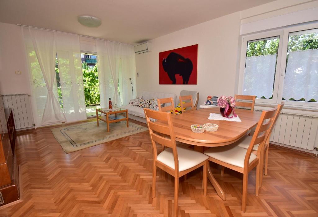 a dining room with a wooden table and chairs at Sunny Heaven Apartments in Izola