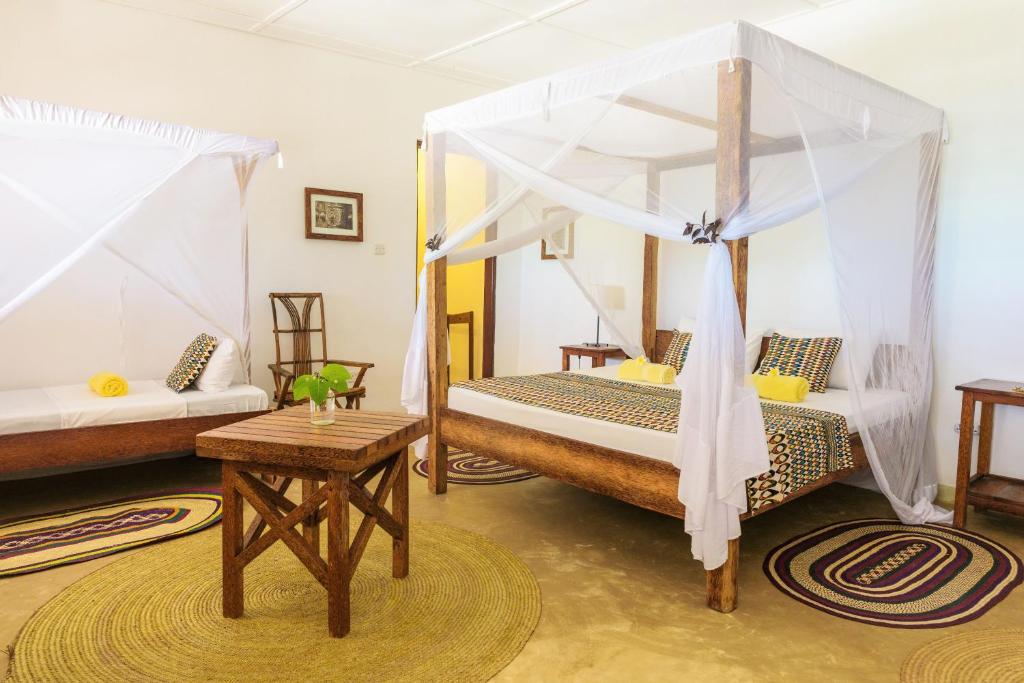 Postel nebo postele na pokoji v ubytování Maji Lodge